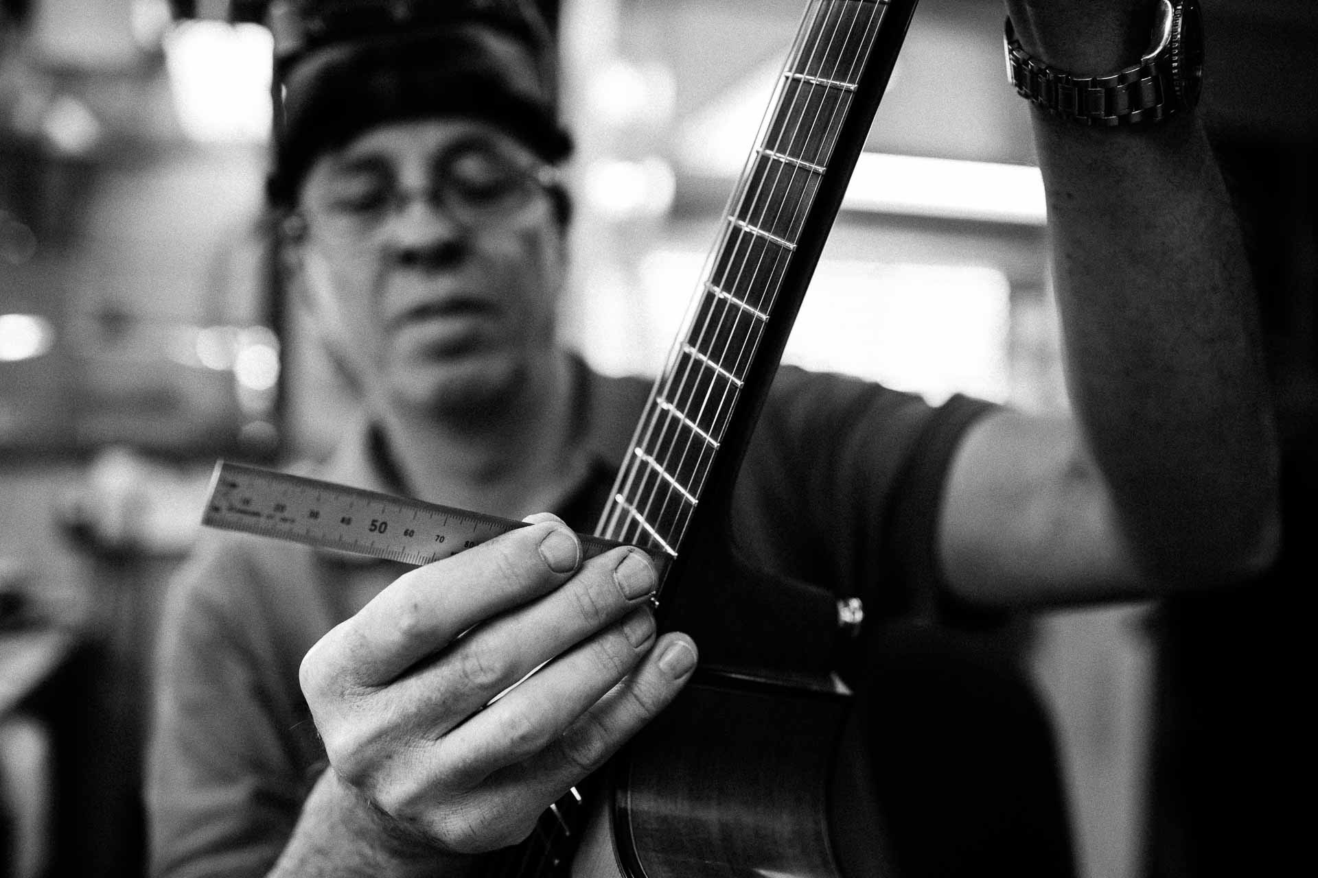 Chris Melville, guitar repairer in Brisbane, working on a guitar's frets